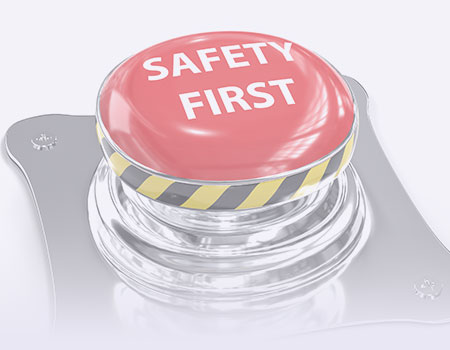 Red emergency button with the words safety first written on it representing workplace safety and  OSHA Nursing CEUs