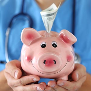 Nurse in scrubs with stethoscope holding pink piggy bank to show money saving on CE
