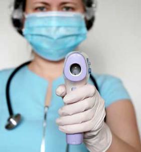 Nurse holding up a medical instrument