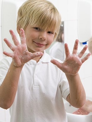 Kid shows his well washed hands