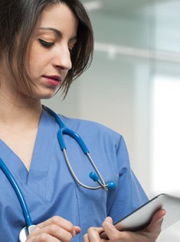 Nurse works on her tablet taking a CEU course.
