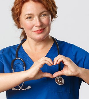 Nurse creates a heart shape with her hands.
