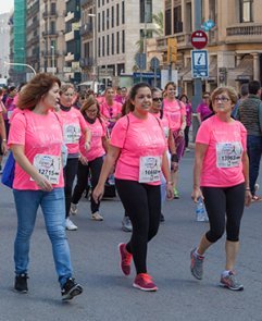 Three ladies wearing pink in a Awareness March for Breast Cancer