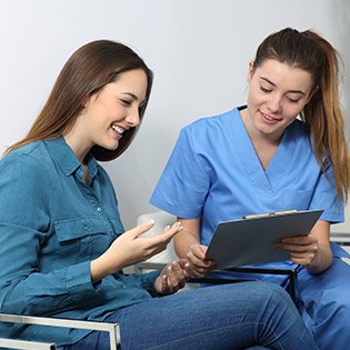 Nurse conducting an admissions interview with her patient