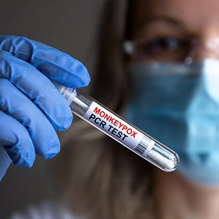 Nurse holding up a testtube.