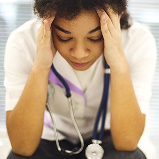 Busy nurse starts to feel the onset of stress.
