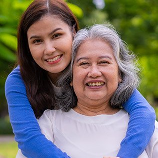 Nurse hugging her family member.