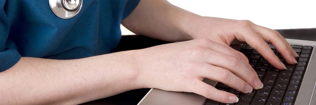 Nurse writes down her goals and plans on her laptop.