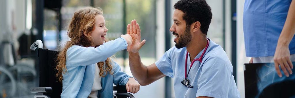 Nursing is rewarding.
Nurse and little girl exchange a high five before she is released.