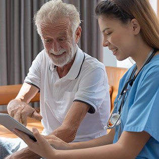 Nurse and elderly patient having a laugh together.