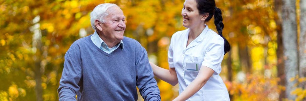 Elderly patient exercising outdoors.