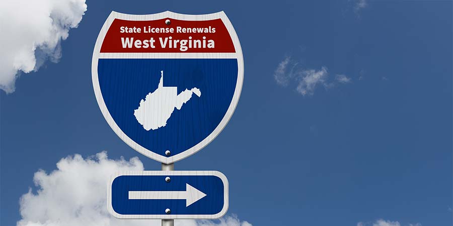 A traditional american blue and red road sign with State License Renewals West Virginia written on it and an arrow pointing to the right