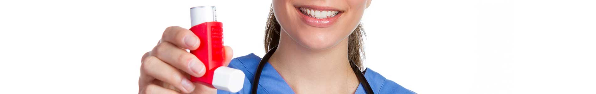 Smiling female nurse in blue scrubs with black stetoscope around her neck holding a red and white Asthma inhaler in her hand