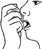 Patient inserting an inhaler into mouth