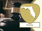 Dark-wood and gold gavel representing laws and rules and Florida state outline