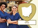 Two young smiling diverse nurses in blue scrubs with crossed arms and Ohio state outline