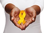 Two hands pointing towards viewer, holding yellow ribbon representing suicide prevention and West Virginia state outline