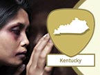 Injured and sad-looking woman with black eye from domestic violence and Kentucky state outline