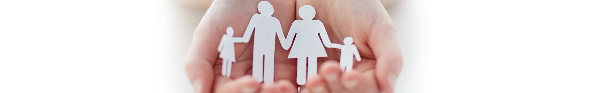 Outstretched hands coming together to form a cup containing paper cut out dolls representing protection of a family
