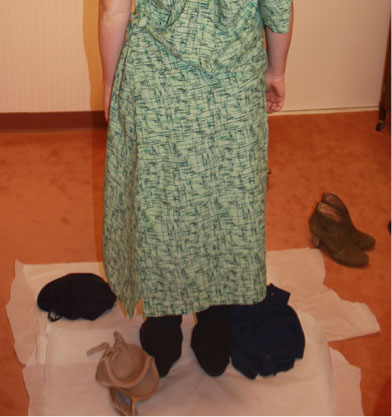 Forensic examination clothing collection photo showing patient disrobing on floor covering.
