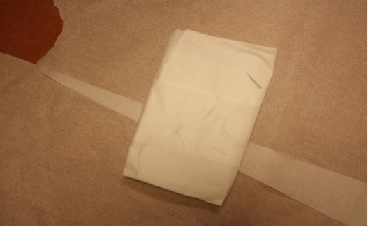 Forensic examination clothing collection photo showing folded floor covering.
