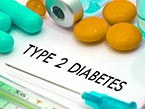 Four Orange and three turquoise pills and an ampoule with needle laying on a paper with Diabetes Type 2 writing