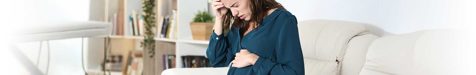 White pregnant lady in distress and preparing to seek medical help