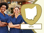 Two young smiling diverse nurses in blue scrubs with crossed arms and Ohio state outline