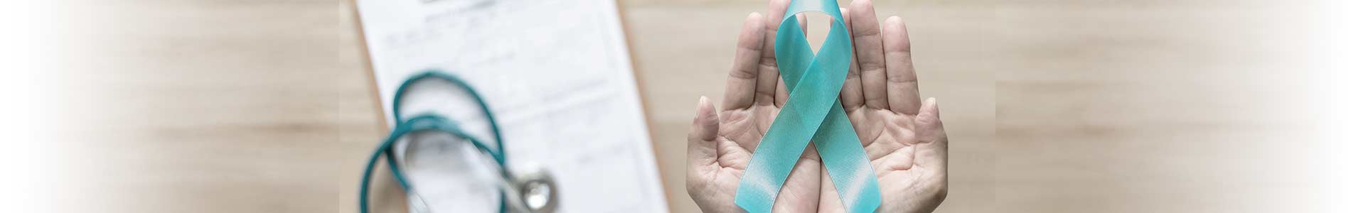Two hands holding up a teal colored ribbon, the symbol of sexual violence prevention, with a background of a doctors notepad and stethoscope