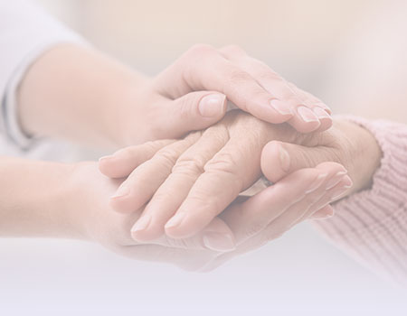 Hand of elderly female between pair of hands of younger wrinkle free hands representing gerontology CEUs for Nurses