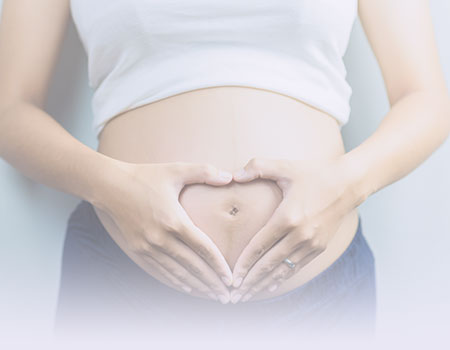 Pregnant woman holding her hands as a heart on her naked belly wrepresenting labor and delivery and obstetrics Nursing CEUs