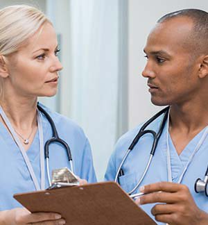 Nurses discussing patient chart Nurses discussing patient chart